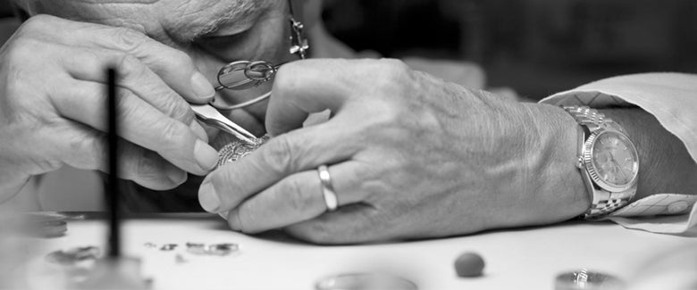 Watchmaker servicing a luxury watch